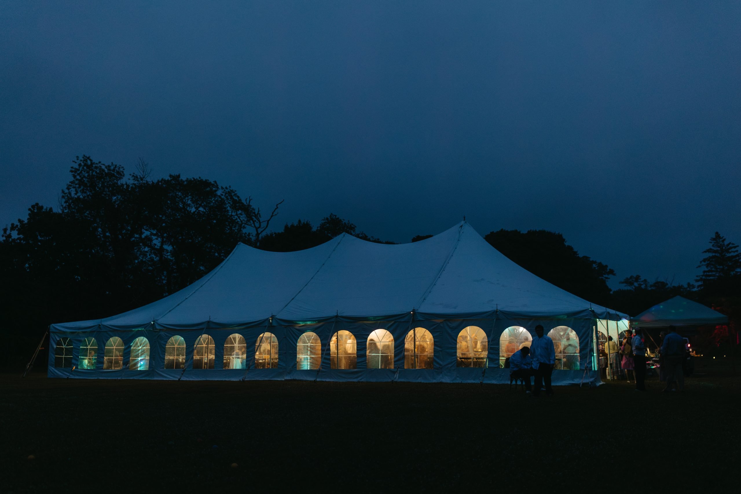 Difference between a sailcloth and canopy tent styles by Baystate Tent & Party: Canopy wedding tent at night