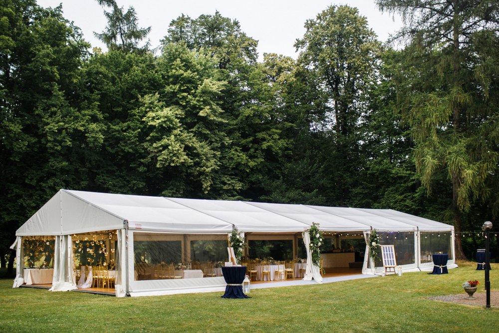 A long, enclosed, white event tent before a commercial event
