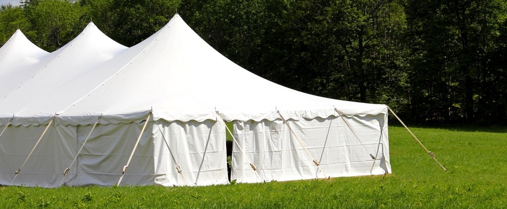 A closeup of an event tent surrounded by sidewalls