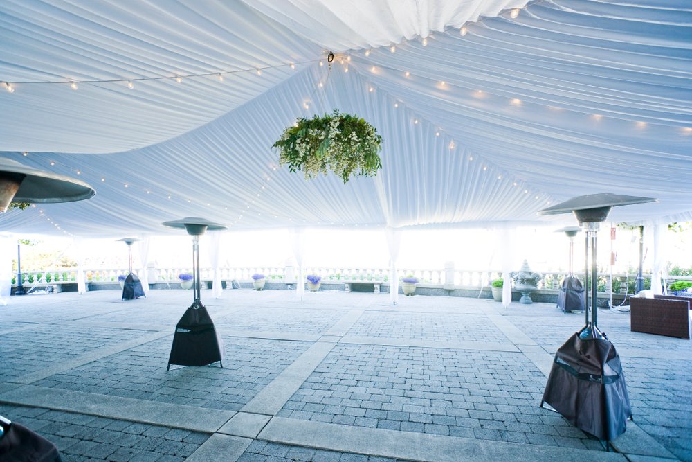 A closeup of the inside of an event tent with several heaters visible, which are vital for winter outdoor events